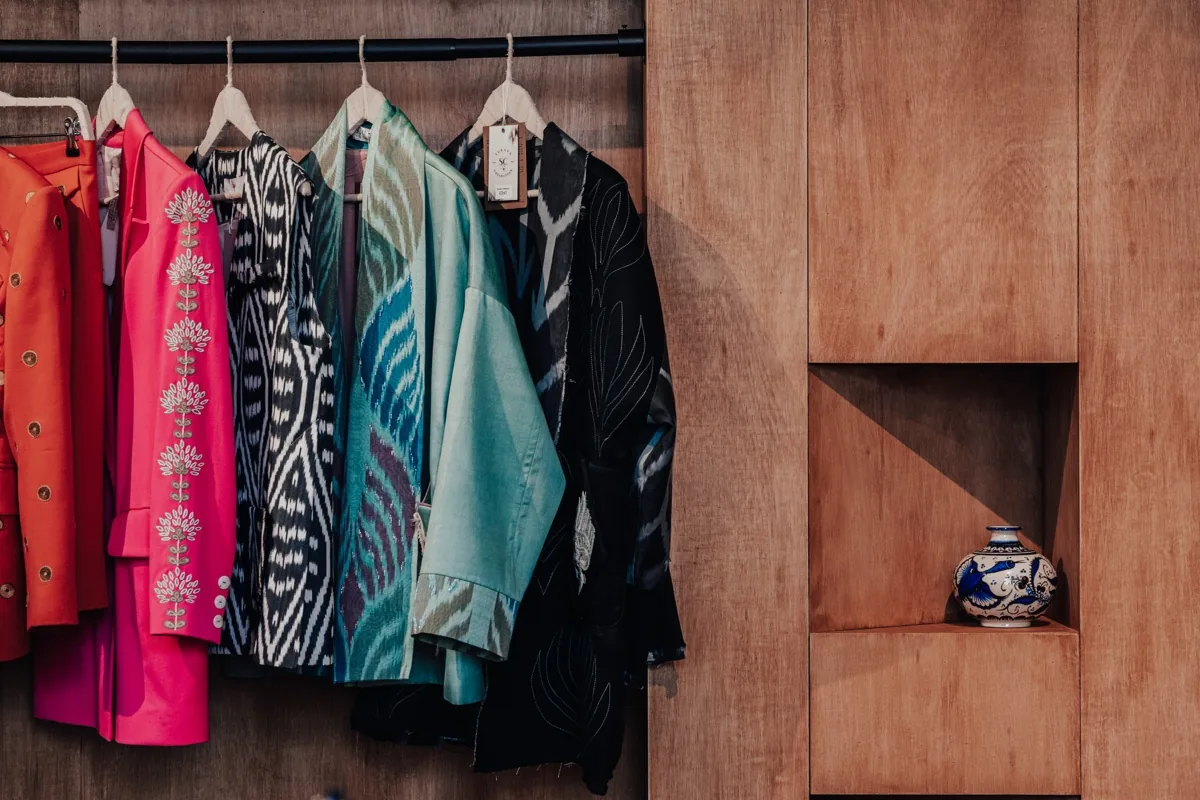 Hand-woven ikat jackets on a wooden rail